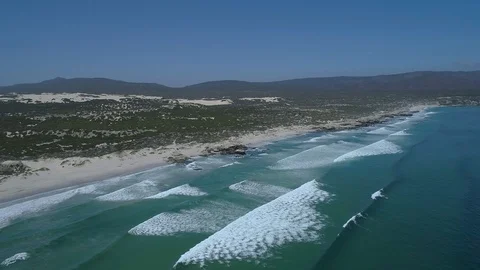 Aerial - Sets of waves running out on to the beach Stock Footage 91319531