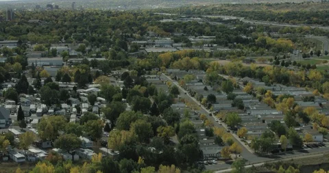 Aerial of settlement, green trees and mountain ranges Stock Footage 96388341