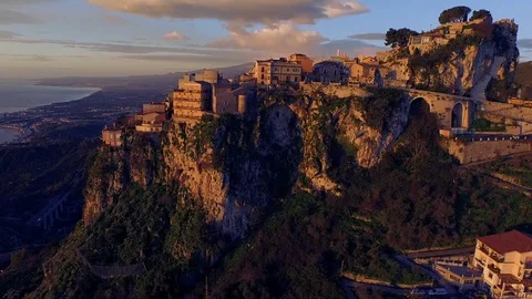 Aerial of settlement on top of cliff at sunset Stock Footage 89966409