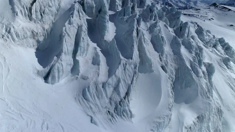 Aerial sharp peaks mountain glacier frozen layered azure ice Russia Elbrus sight Stock Footage 128032163