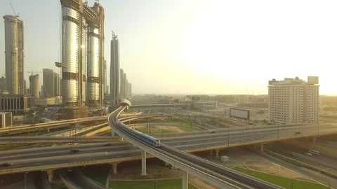Aerial. Sheikh Zayed Road Intersection and Dubai Metro train. 4K. Stockbeeldmateriaal 79904736