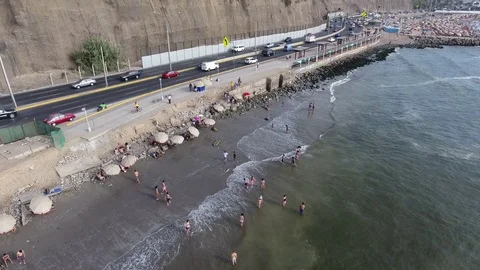 Aerial of shingle beach with traffic in background Stock Footage 72869956