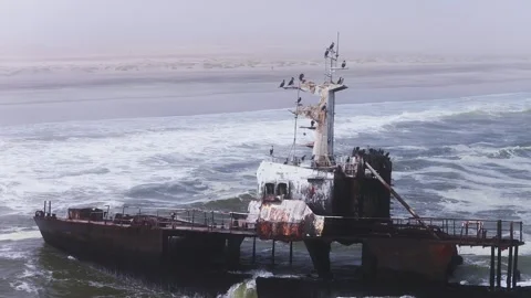 Aerial shipwreck at Skeleton Coast Namibia with surf and dunes Stock Footage 341423488