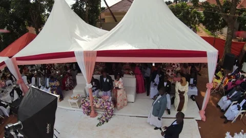 Aerial shoot of the drone showing the different Africans on the wedding function Stock Footage 157702821