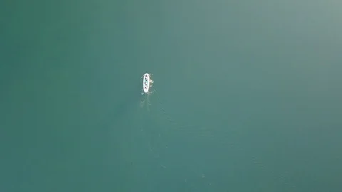 Aerial shoot of A group of SUP surfers floating in Harfravatn lake in Iceland Stock Footage 118347189