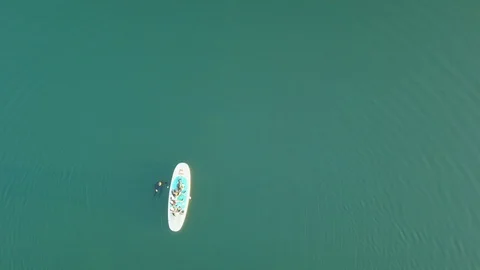 Aerial shoot of A group of SUP surfers floating in Harfravatn lake in Iceland Video stock 118348561