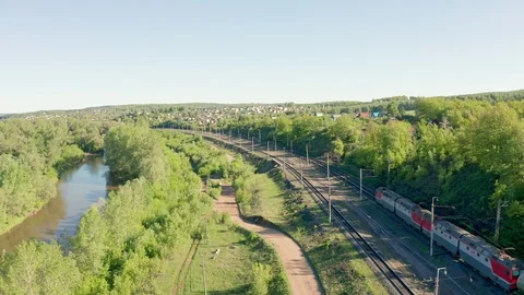 Aerial shoot of a passing freight train.The railway is located along the river. Stock Footage 111402879