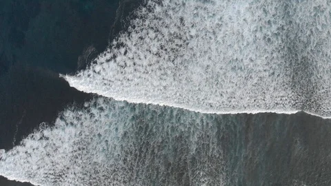 Aerial shooting of big ocean waves and surfers on the island of Bali. Stock Footage 103290544