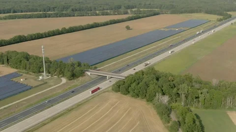 Aerial shooting of a complex of ecological solar panels near the highway Stock Footage 163240847