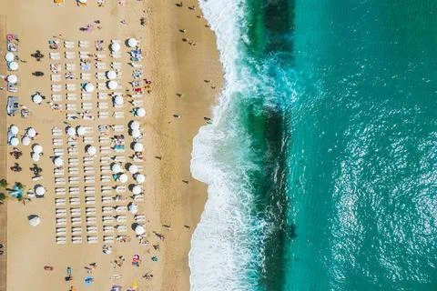 Aerial shooting from a drone on a sandy beach with people sunbathing and Stock Photos