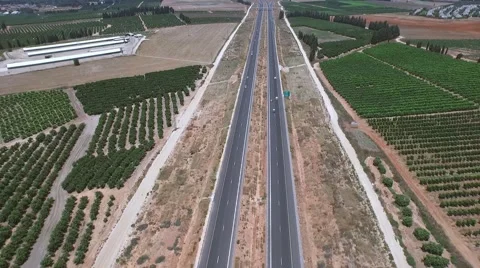 Aerial shooting of the highway in the middle of fields Stock Footage 54296643