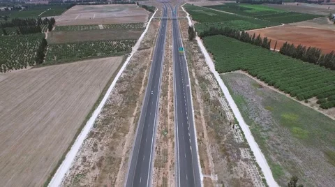 Aerial shooting of the highway in the middle of fields Stock Footage 54296644