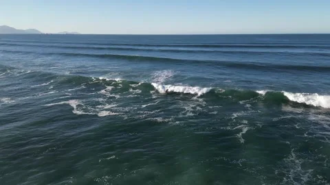 Aerial shooting man doing surf in beach Stock Footage 258835031