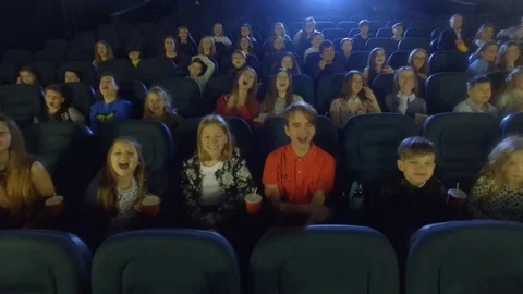 Aerial shot, 4K. Video frames at the cinema with funny kids, who watch cartoon Stock Footage 75956067