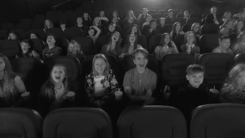 Aerial shot, 4K. Video frames at the cinema with funny kids, who watch cartoon Stock Footage 75956127