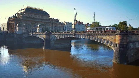 Aerial shot about river close to National Theatre with tram on the bridge in Stock Footage 103222533