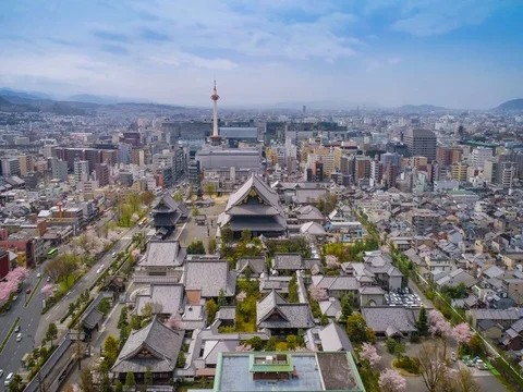 Aerial shot above buddhist temple and Kyoto Tower, Japan Stock Footage