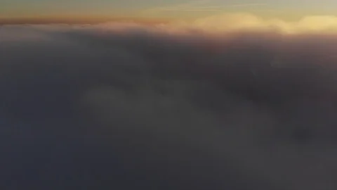 Aerial shot above thick clouds upper surface against horizon Stock Footage 103282908