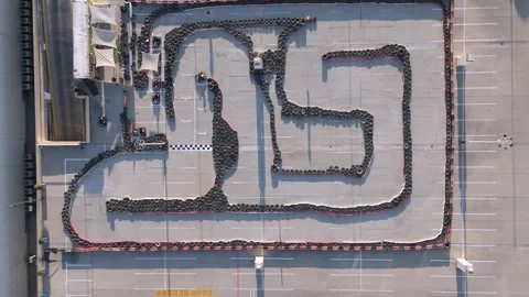 Aerial Shot of almost empty Go-Kart Circuit with Intricate Design on Sunny Day Video stock 296170132