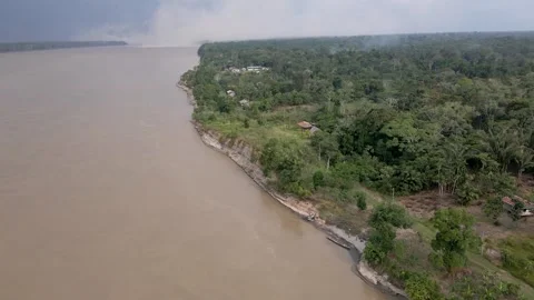 Aerial shot of the Amazon River with lush greenery along the shore in Iquitos Stock Footage 304414933