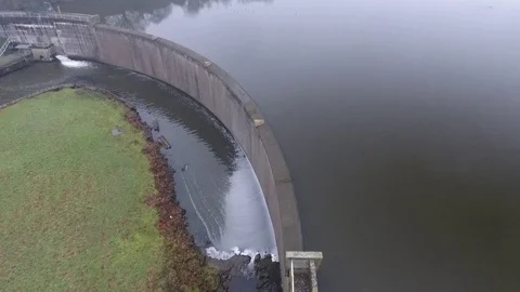 Aerial shot around a water dam with a light mist Stock Footage
