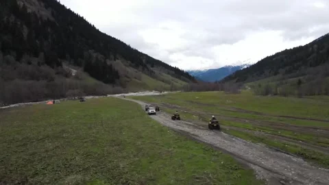 Aerial shot of ATVs and off-road cars in Arkhyz mountain valley Vídeos de archivo 337712341