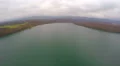 Aerial shot of autumn landscape, wide still river, gray clouds in sky on horizon 4k or 4k+ Resolution