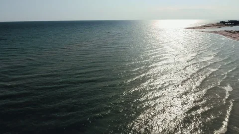 Aerial shot of beautiful sun path on the Black Sea waves at sunset in summer Stock Footage 124414413