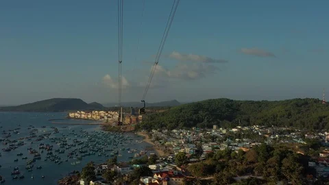 Aerial shot below cable car above mountain and old fishing town close of harbou Video stock 124366029