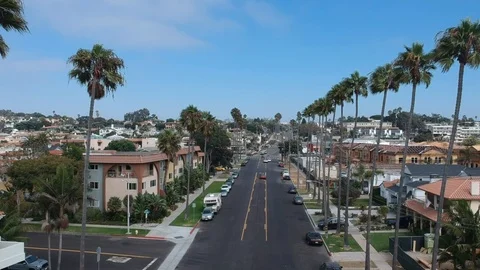Aerial shot between palm trees, yellow car Stock Footage 103104195