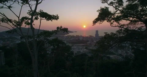 Aerial Shot Between Trees Towards Patong Beach in Phuket Thailand Video stock 63067976