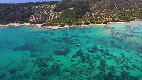 Aerial shot of the boat moving in the blue and clear waters of the Aegean Sea Video stock 239323341