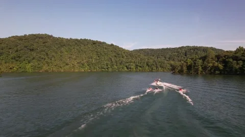 Aerial Shot Of Boat Pulling Three Inflatable Tubes In Lake, Drone Tracking Video stock 201761581
