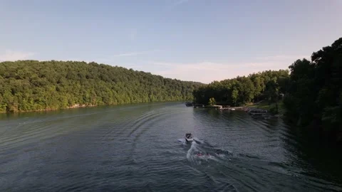 Aerial Shot Of Boat Pulling Three Inflatable Tubes In Lake, Drone Tracking Video stock 201761666