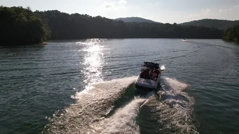 Aerial Shot Of Boat Pulling Three Inflatable Tubes In Lake, Drone Tracking Video stock 201761668