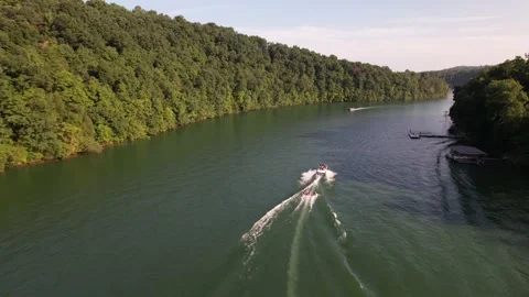 Aerial Shot Of Boat Pulling Three Inflatable Tubes In Lake, Drone Tracking Video stock 201761737