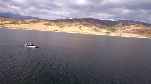 Aerial shot of a boat traveling across lake Stock Footage