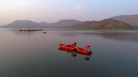 Aerial Shot of boats on a lake, old palace in the background Stock Footage