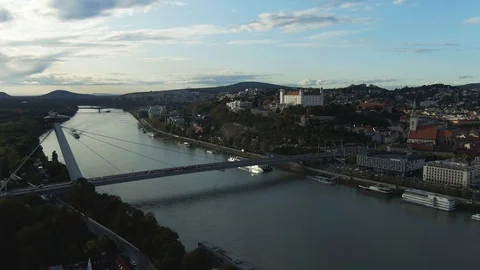 Aerial Shot of Bratislava Castle And SNP UFO Bridge Over Danube River In Sunset Stock Footage 118291753