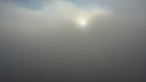 Aerial Shot Breaking through the Clouds with Sun Video stock 129042973