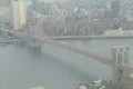 Aerial shot of Brooklyn Bridge with zoom out to Manhattan Skyline & twin towers Footage