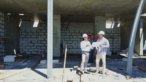 Aerial Shot Of Builders Team On Construction Site Discussing Plan Of Project Stock Footage