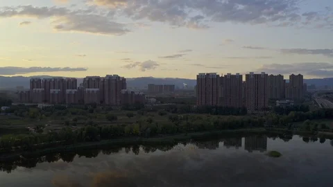 Aerial shot of building beside a national park in china Stock Footage