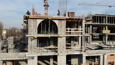 Aerial Shot of the Building in the Process of Construction with Labor working Stock Footage 104899424