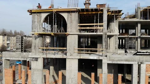 Aerial Shot of the Building in the Process of Construction with Labor working Stock Footage 104899426
