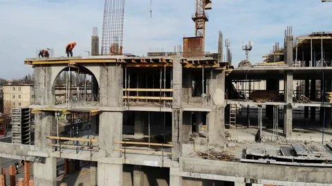 Aerial Shot of the Building in the Process of Construction with Labor working Stock Footage 104899429