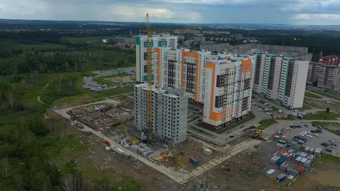 Aerial Shot of the Building in the Process of Construction. Labor working in big Stock Footage 113568766