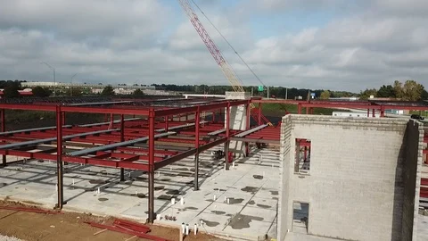 Aerial shot of building under construction near a highway Stock Footage 100306837