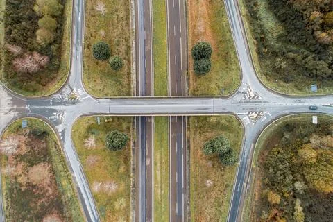 Aerial shot of a busy intersection with multiple lanes of highway traffic Stock Photos