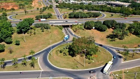 Aerial shot of a busy intersection surrounded by green trees. Brazil. Stock Photos
